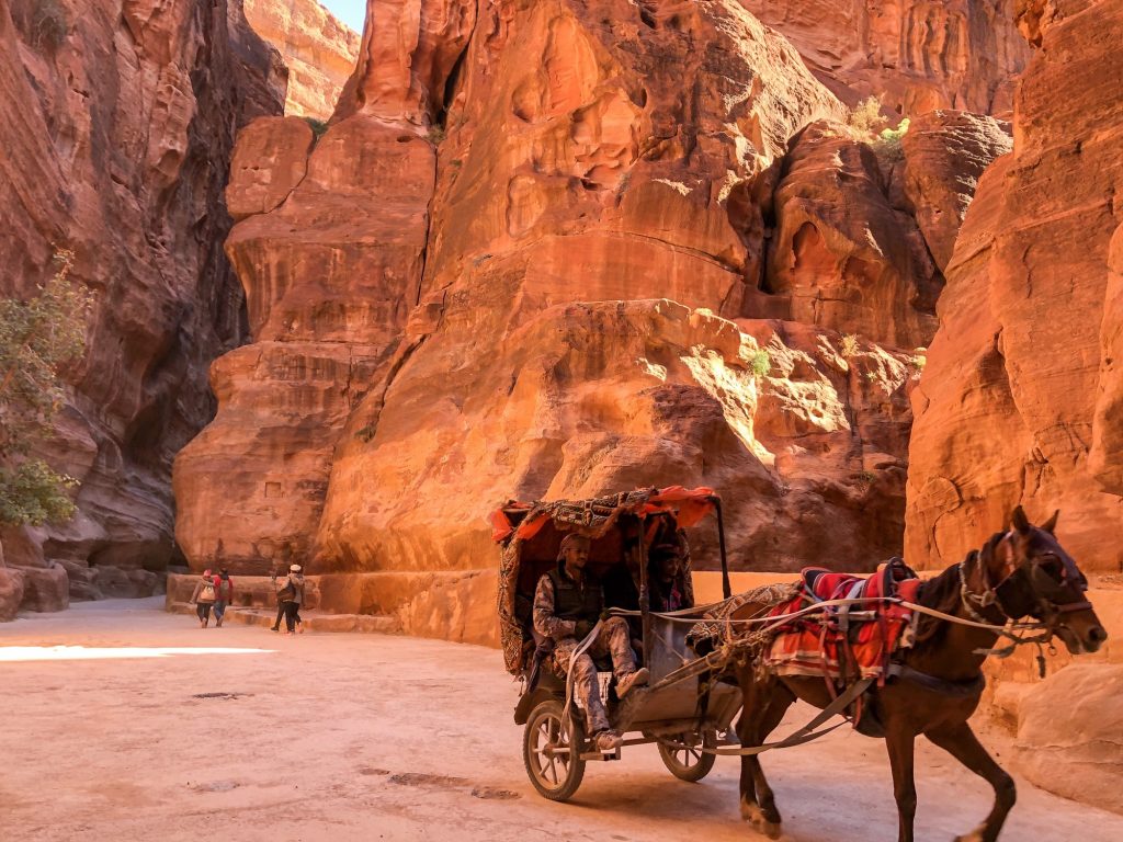 Traveling through the Al Siq via horse carriage like in the olden days
